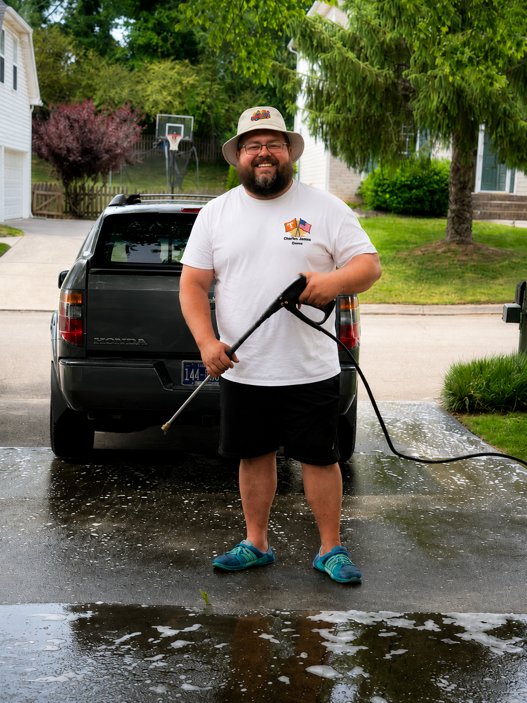 Charles James pressure washing a driveway